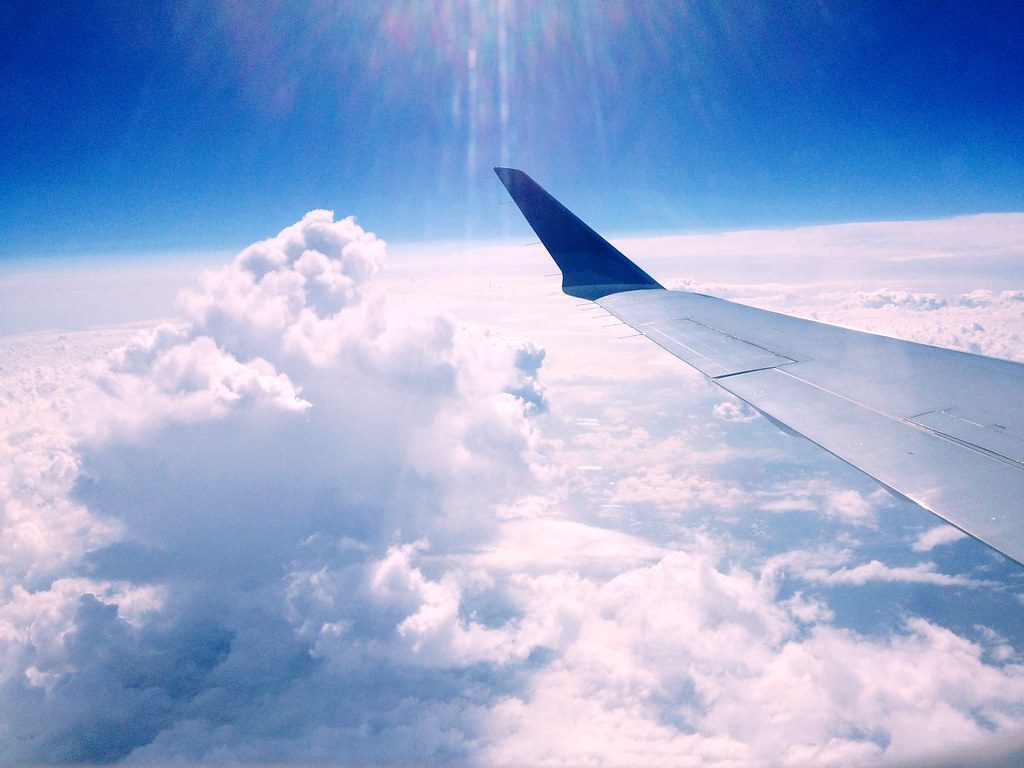 The view from an aeroplane window over a thick layer of cloud.