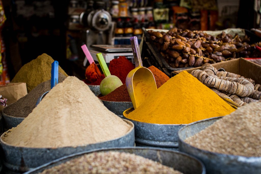 Cones of brightly coloured spices in a Moroccan market stall.