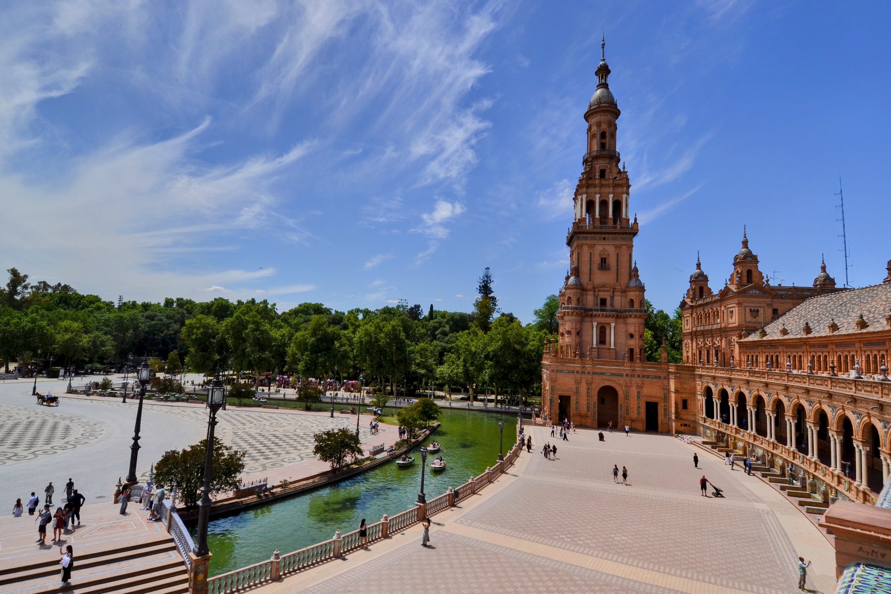 The curved colonnade and canal of the Plaza de Espana in Seville.